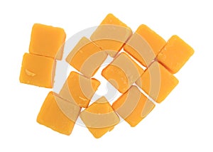Cubed mild cheddar cheese on a white background