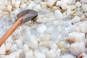 Cubed pork fat being rendered