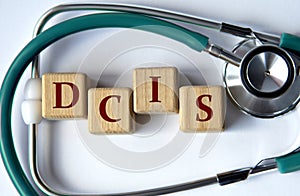 Cubes with the abbreviation DCIS on the background of a stethoscope