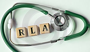Cubes with the abbreviation RLA on the background of a stethoscope