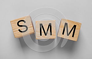 Cubes with abbreviation SMM Social media marketing on light grey background