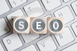 Cubes with the acronym SEO for search engine optimization