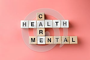 Cubes composed words MENTAL HEALTH CARE on color background