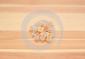 Cubes of crystallised stem ginger on wood