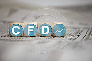 Cubes, dice or blocks with acronym CFD - Contracts For Difference on wooden background photo