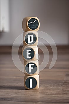 Cubes, dice or blocks with acronym DEFI - Decentralized Finance on wooden background