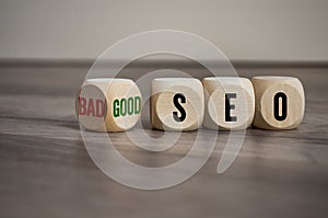 Cubes, dice or blocks with bad or good seo on wooden background