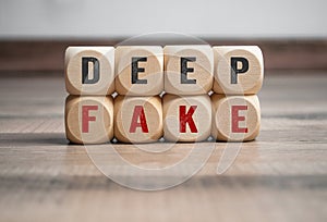 Cubes, dice or blocks with deep fake, deepfake on wooden background photo