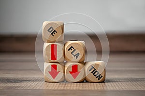 Cubes, dice or blocks with deflation on wooden background