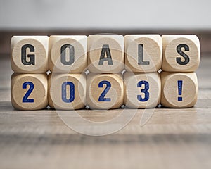 Cubes, dice or blocks with goals 2023 on wooden background