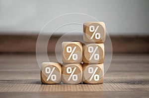 Cubes, dice or blocks with percent sign symbols on wooden background