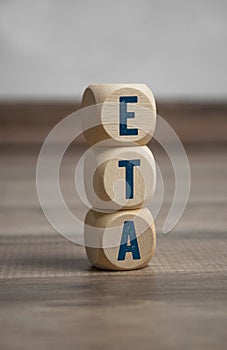 Cubes and dice with ETA Estimated time of arrival on wooden background
