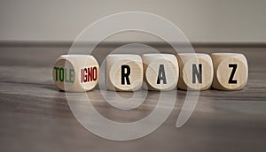 Cubes and dice with german words for tolerance and ignorance - toleranz und ignoranz on wooden background photo