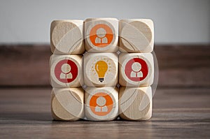 Cubes and dice with light bulb icon and idea - plan do check act on wooden background