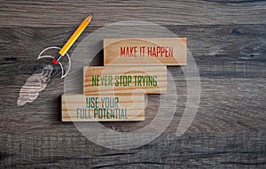 Cubes and dice showing the words Make it Happen on wooden background