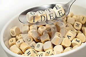 Cubes dice with with spoon alphabet soup with the german words for good idea - gute idee