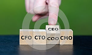 Cubes form the abbreviations 'CFO, CTO, COO, CMO and CEO' as symbol for hierarchy of the leadership in a company