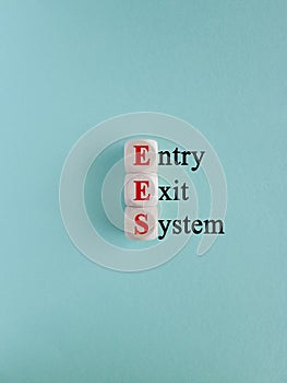 Cubes form the acronym EES- Entry Exit System. Beautiful blue background. Business concept