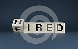 Cubes form the words Hired - Fired. Business and job concept