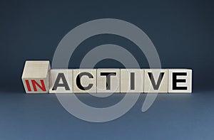 Cubes form words Inactive or Active. The concept of activity both in business and in life photo