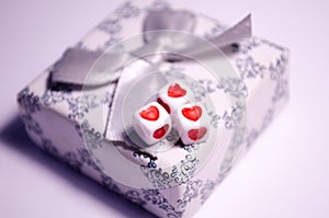 Cubes with hearts. The 14th of February. Hearts on white cubes. White background and cubes side view. Dice beads. White background