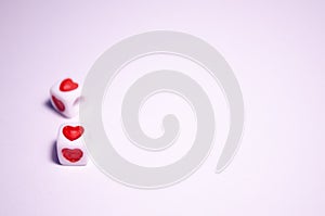 Cubes with hearts. The 14th of February. Hearts on white cubes. White background and cubes side view. White background