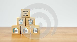 Cubes with house symbols and message BUYING OR RENTING - 3d illustration
