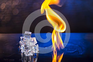 cubes of ice and fire on a water surface on an abstract background