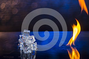cubes of ice and fire on a water surface on an abstract background