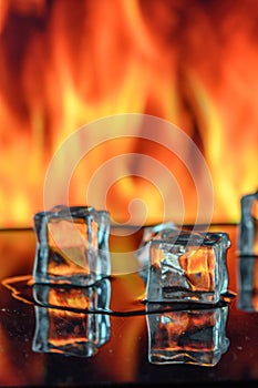 three ice cubes against the background of fire, fire and ice, place under the text 2