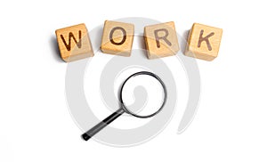 Cubes labeled work with magnifying glass. Concept of job search or workers. hiring specialists and specialized workers. Search