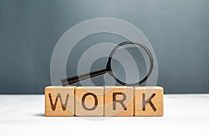 Cubes labeled work and magnifying glass on top. Human resources, hiring specialists and specialized workers. Search for a new