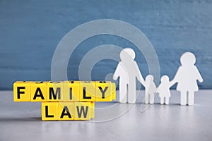 Cubes with letters and family figure on table. Family law concept