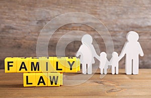 Cubes with letters and family figure on table. Family law concept