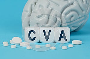 Cubes lie on the table among the pills and imitation of the brain. The text on the dice - CVA photo