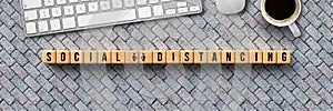 Cubes with message SOCIAL DISTANCING and computer keyboard