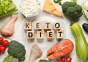 Cubes with phrase Keto Diet and different fresh products on white wooden table, flat lay