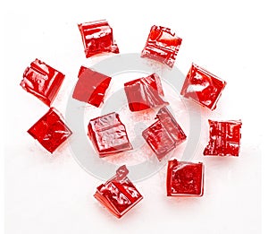 Cubes of red strawberry jelly on a white background