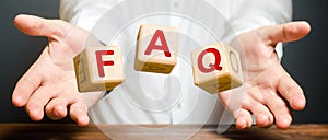 Cubes thrown by a man make word abbreviation acronym FAQ frequently asked questions. Instructions and rules. Avoid frequent