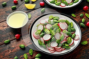 Cucamelon radish salad on rustic wooden table. healthy summer food photo