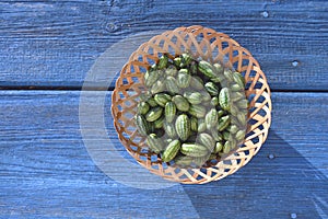 Cucamelons Melothria scabra in wicker basket on blue table