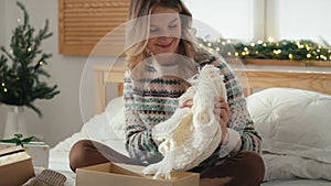 Cucasian woman opening Christmas presents