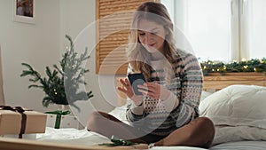 Cucasian woman using mobile phone at Christmas