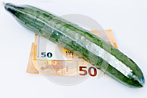 Cucumber in cellophane on banknotes