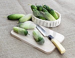 Cucumber fresh and knife on wooden cutting board on sackcloth background for cooking ingredient in food healthy