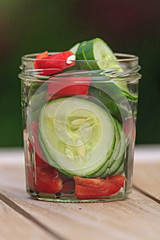 Cucumber with herbs in a jar