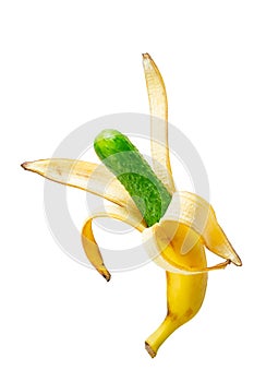 cucumber inside opened banana peel. Genetically modified fruit isolated on white background. Contemporary art collage