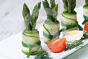 Cucumber rolls with asparagus close up