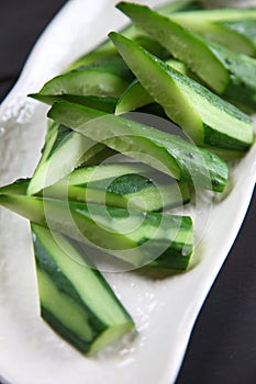 Cucumber salad on dark background