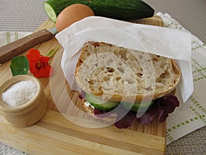 Cucumber sandwich in greaseproof paper bag